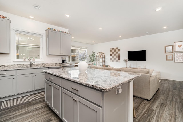 kitchen featuring a kitchen island, dark wood finished floors, and gray cabinets