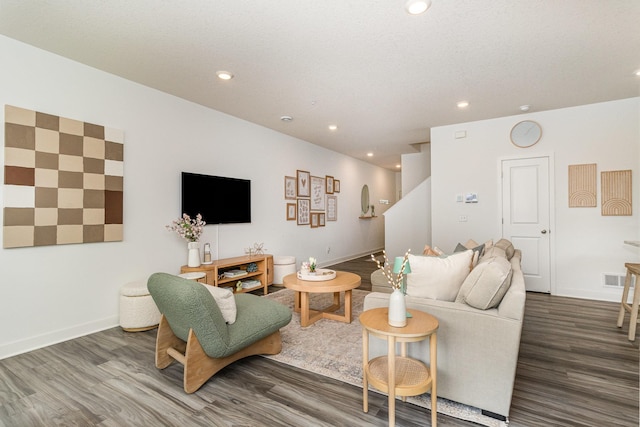 living room with visible vents, baseboards, recessed lighting, wood finished floors, and stairs
