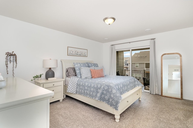 bedroom with access to outside and light carpet
