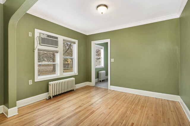 4348 Minnehaha Ave, Minneapolis, MN 55406 - spare room featuring radiator heating unit, light wood-style flooring, crown molding, and baseboards