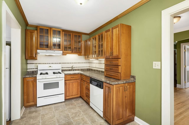 4348 Minnehaha Ave, Minneapolis, MN 55406 - kitchen with white appliances, decorative backsplash, crown molding, under cabinet range hood, and brown cabinets