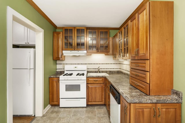4348 Minnehaha Ave, Minneapolis, MN 55406 - kitchen featuring white appliances, under cabinet range hood, brown cabinetry, decorative backsplash, and a sink
