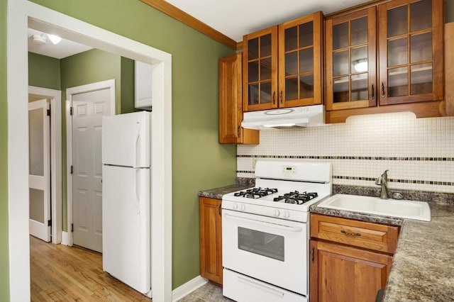 4348 Minnehaha Ave, Minneapolis, MN 55406 - kitchen with white appliances, under cabinet range hood, a sink, tasteful backsplash, and ornamental molding