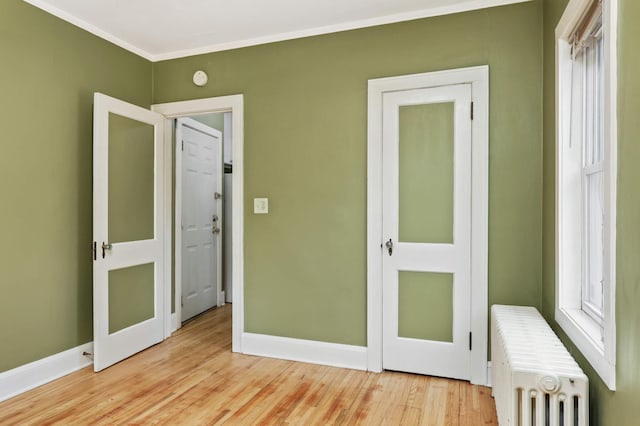 4348 Minnehaha Ave, Minneapolis, MN 55406 - unfurnished bedroom with radiator, baseboards, light wood-style floors, and crown molding