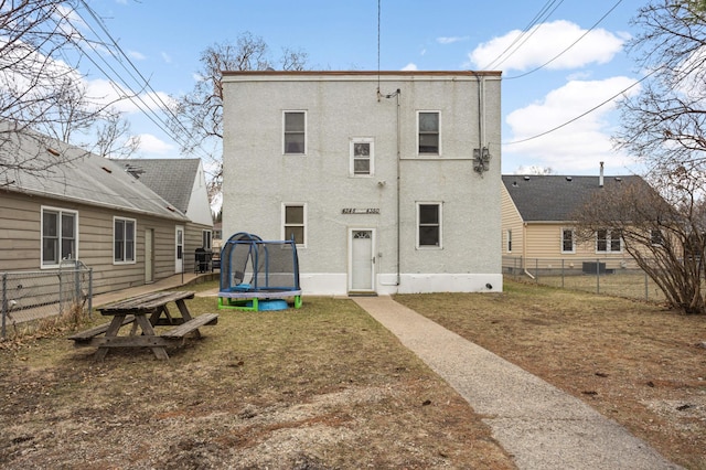 4348 Minnehaha Ave, Minneapolis, MN 55406 - rear view of house with a trampoline and stucco siding