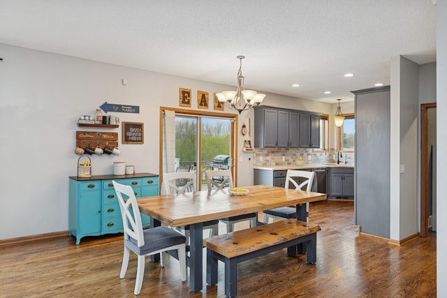 dining room featuring a notable chandelier, a wealth of natural light, and wood finished floors