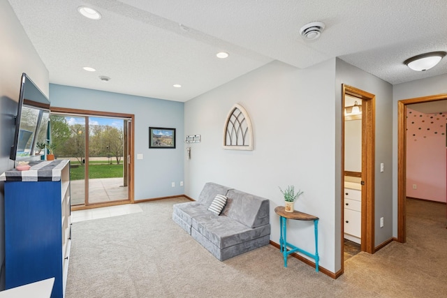 living area featuring light colored carpet, recessed lighting, a textured ceiling, and baseboards