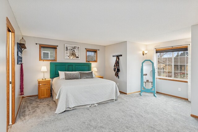 carpeted bedroom featuring baseboards