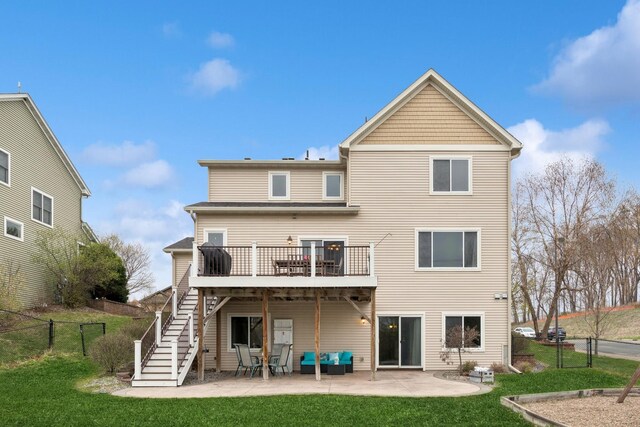 back of house featuring a lawn, a wooden deck, a patio area, and stairway