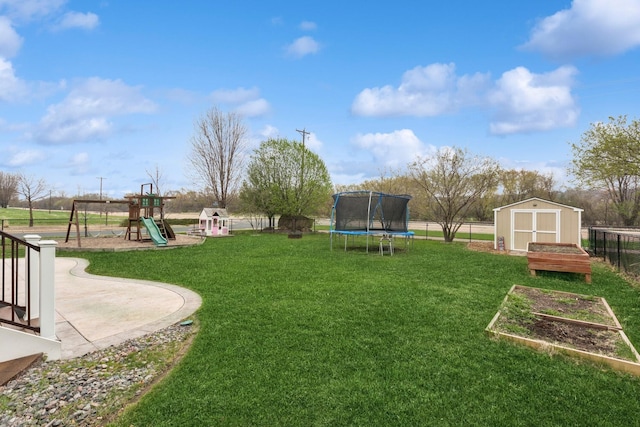 view of yard with a trampoline, fence, an outdoor structure, a playground, and a storage unit