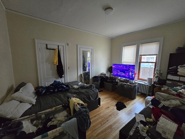 bedroom with hardwood / wood-style flooring and crown molding
