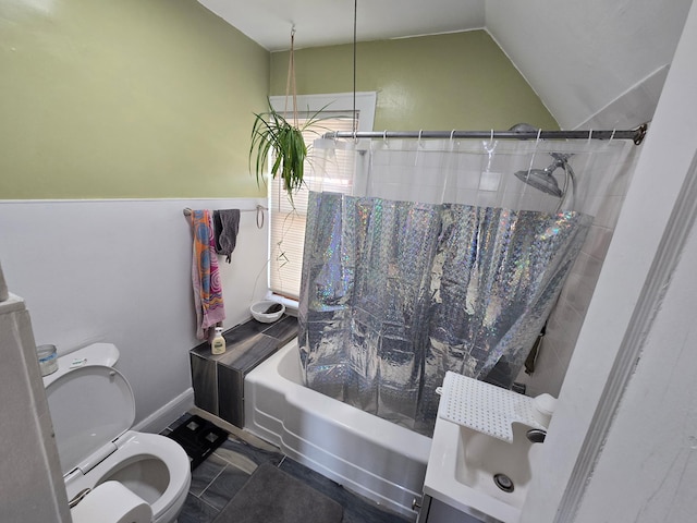 bathroom with shower / bath combination with curtain, vaulted ceiling, and toilet