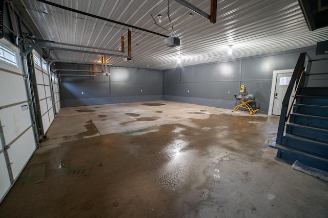 garage featuring a garage door opener and metal wall