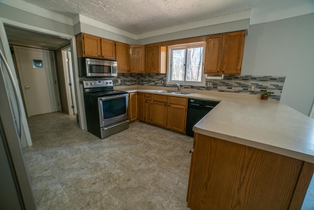 kitchen featuring brown cabinetry, a sink, and stainless steel appliances