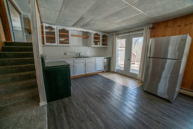 kitchen featuring freestanding refrigerator, dark wood finished floors, light countertops, black electric range oven, and french doors