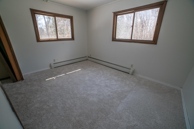 unfurnished bedroom featuring crown molding, baseboards, carpet flooring, and a baseboard heating unit