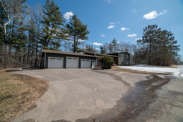 single story home with driveway and a garage