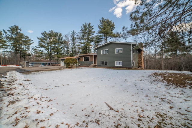 view of snow covered rear of property