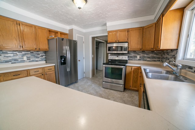 50 Maryhill Ln, Aitkin, MN 56431 - kitchen with stainless steel appliances, a sink, light countertops, decorative backsplash, and a textured ceiling