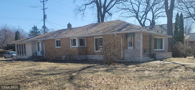 view of home's exterior featuring a chimney, stone siding, and brick siding