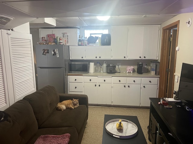 kitchen with visible vents, light countertops, white cabinets, and stainless steel appliances