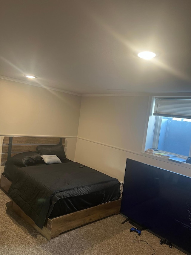 bedroom with ornamental molding and carpet flooring
