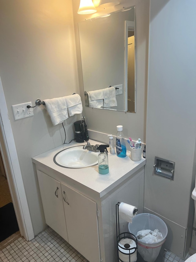 half bath featuring vanity and tile patterned flooring