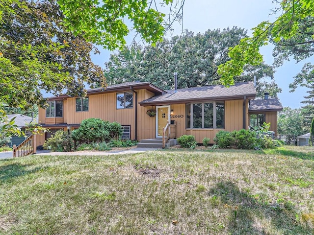 tri-level home with a front yard