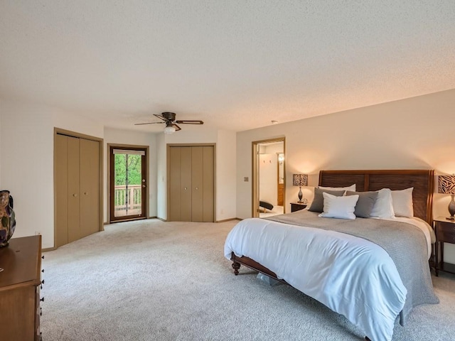 bedroom with carpet floors, ceiling fan, and multiple closets