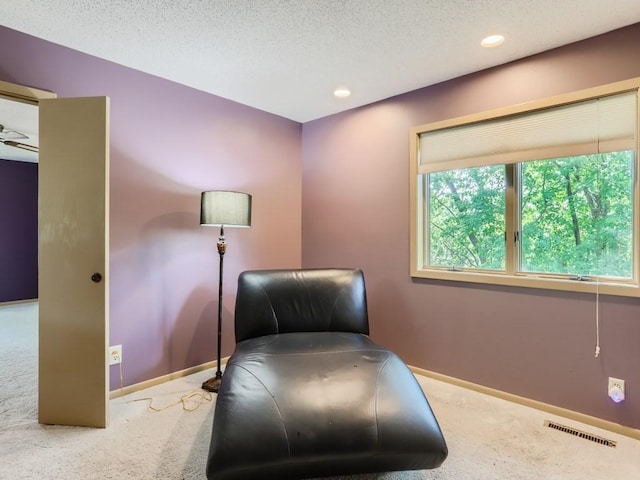 sitting room with baseboards, carpet, and visible vents