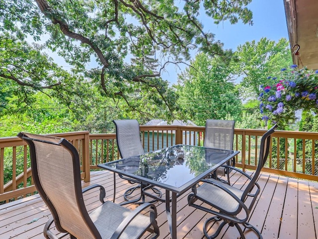 wooden terrace featuring outdoor dining area
