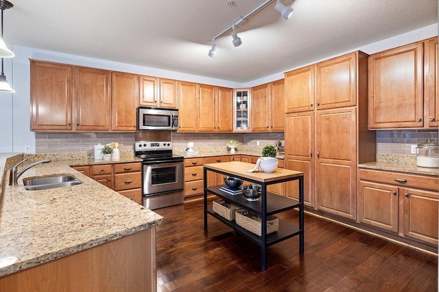 7100 Metro Blvd Unit 206, Edina, MN 55439 - kitchen featuring light stone countertops, glass insert cabinets, a sink, appliances with stainless steel finishes, and backsplash