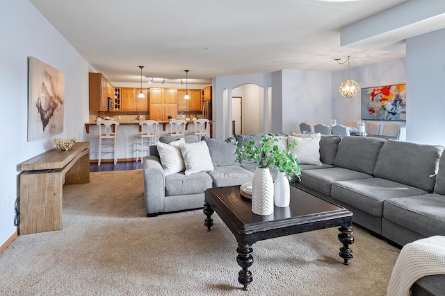 7100 Metro Blvd Unit 206, Edina, MN 55439 - living room featuring an inviting chandelier, arched walkways, and light colored carpet