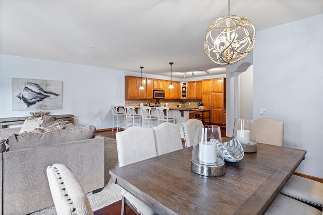 7100 Metro Blvd Unit 206, Edina, MN 55439 - dining area with ornate columns, baseboards, and a notable chandelier