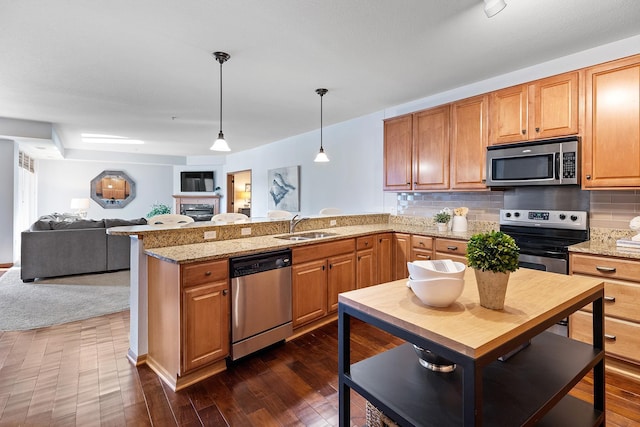 7100 Metro Blvd Unit 206, Edina, MN 55439 - kitchen featuring dark wood-style flooring, a peninsula, open floor plan, a sink, and stainless steel appliances
