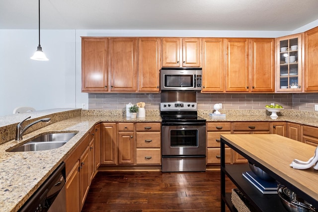 7100 Metro Blvd Unit 206, Edina, MN 55439 - kitchen featuring dark wood-style flooring, light stone countertops, a sink, glass insert cabinets, and stainless steel appliances