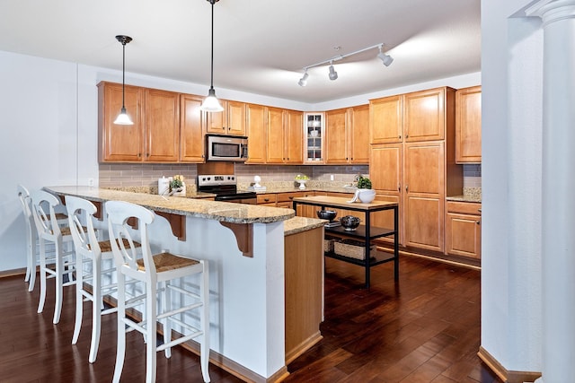 7100 Metro Blvd Unit 206, Edina, MN 55439 - kitchen with backsplash, a peninsula, dark wood-style floors, glass insert cabinets, and stainless steel appliances