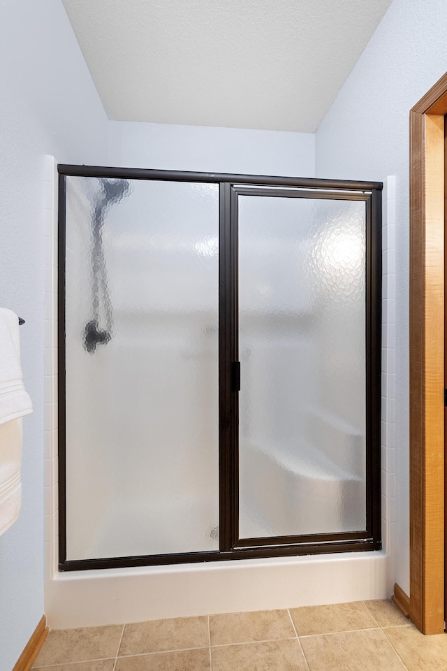 7100 Metro Blvd Unit 206, Edina, MN 55439 - bathroom featuring tile patterned flooring, baseboards, and a stall shower