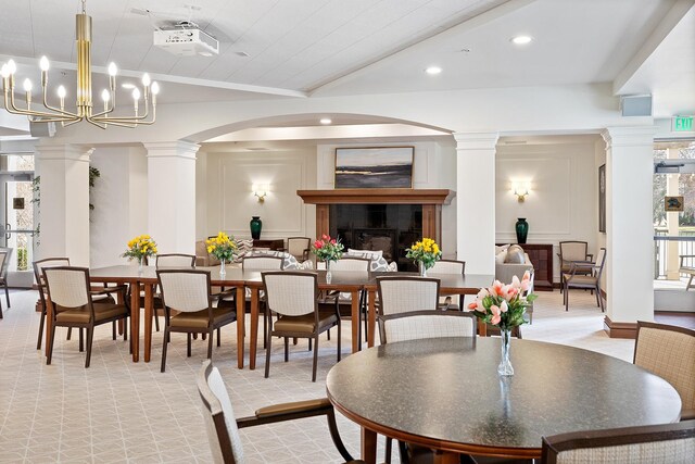7100 Metro Blvd Unit 206, Edina, MN 55439 - dining area with decorative columns, crown molding, arched walkways, a fireplace, and recessed lighting