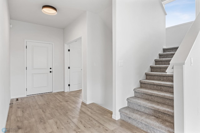 3187 Archer Pl S, Fargo, ND 58104 - foyer entrance with light wood-style flooring, stairs, and baseboards
