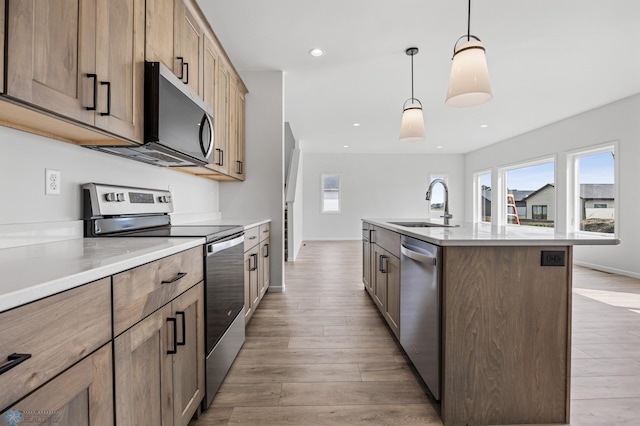 3187 Archer Pl S, Fargo, ND 58104 - kitchen featuring appliances with stainless steel finishes, a sink, light wood finished floors, light countertops, and recessed lighting