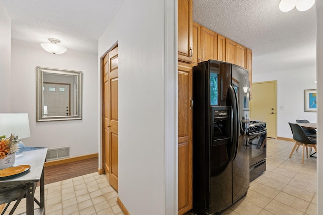 1794 Karis Way, Eagan, MN 55122 - kitchen with black appliances, a textured ceiling, and light tile patterned flooring