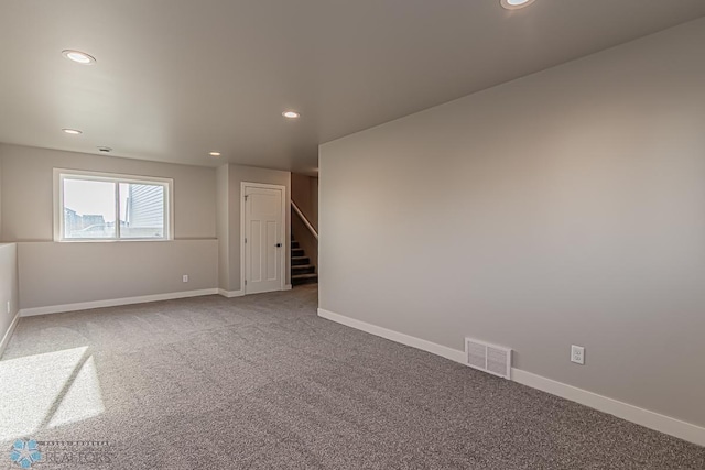 carpeted empty room with recessed lighting, visible vents, and baseboards