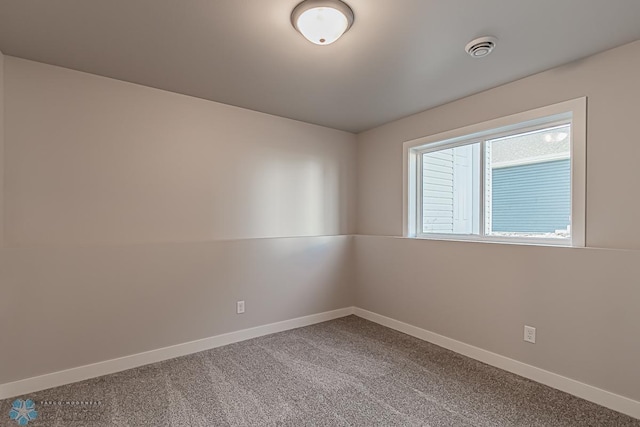 carpeted spare room with baseboards