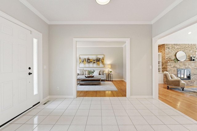 7604 Delaney Blvd, Edina, MN 55439 - entrance foyer featuring crown molding, a brick fireplace, and light wood-style floors
