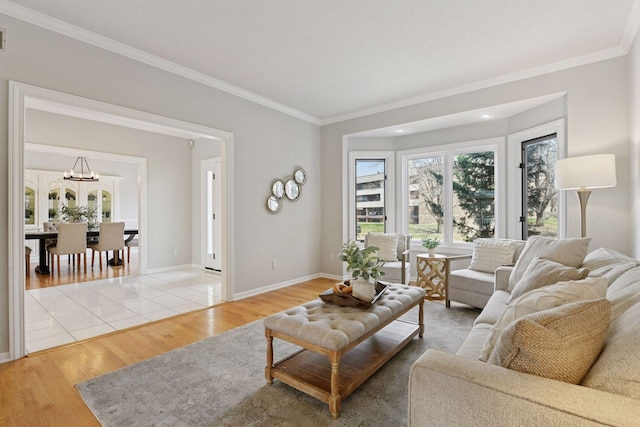 7604 Delaney Blvd, Edina, MN 55439 - living room featuring an inviting chandelier, light wood-style floors, crown molding, and baseboards