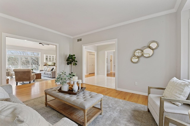 7604 Delaney Blvd, Edina, MN 55439 - living room with baseboards, ornamental molding, a ceiling fan, and light wood finished floors
