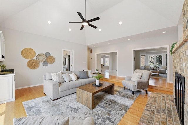 7604 Delaney Blvd, Edina, MN 55439 - living room featuring recessed lighting, a brick fireplace, high vaulted ceiling, ceiling fan, and light wood-style flooring