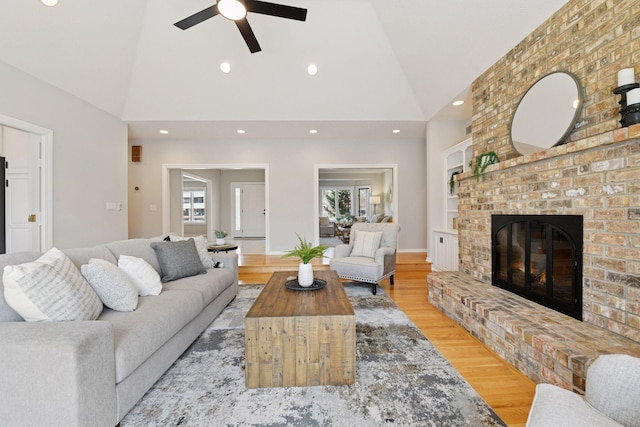 7604 Delaney Blvd, Edina, MN 55439 - living area with light wood-style floors, a ceiling fan, high vaulted ceiling, and a brick fireplace