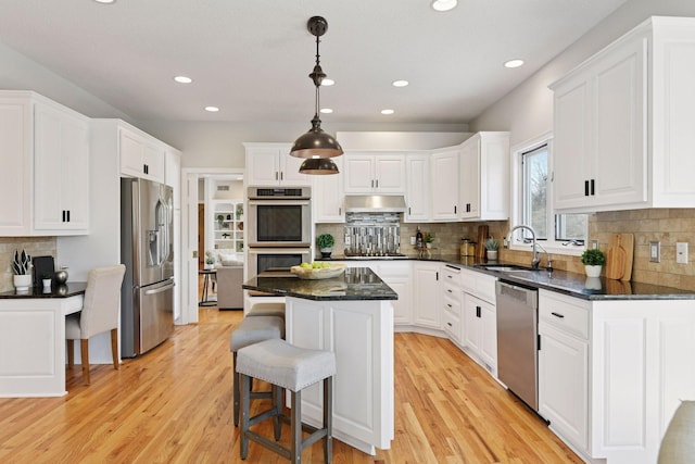 7604 Delaney Blvd, Edina, MN 55439 - kitchen with a center island, a sink, white cabinets, and appliances with stainless steel finishes